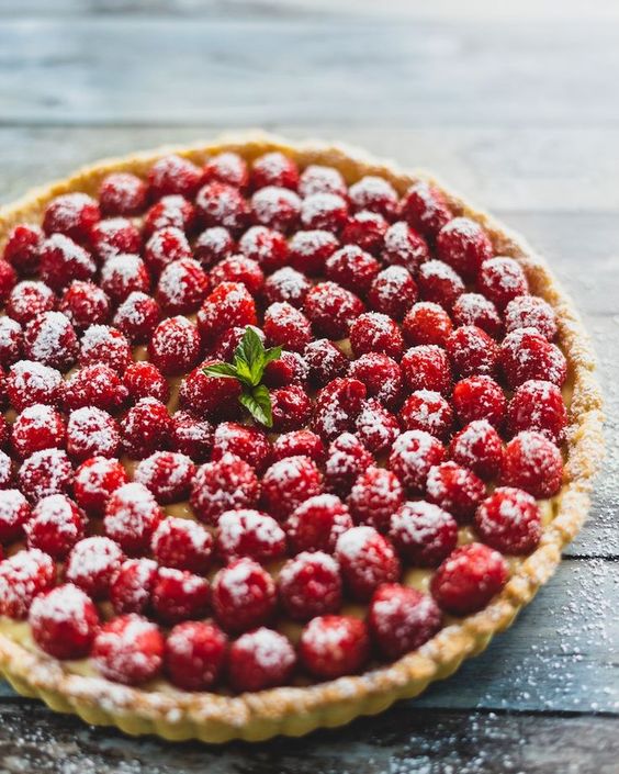 photo of raspberry tart with mint garnish