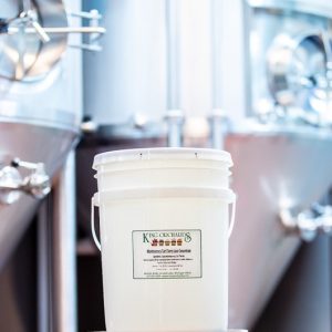 Five Gallons of fruit concentrate in a bucket